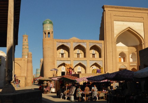 Street vendors sell line the streets of Itchan Kala and sell all sorts of goods including fur hats - Khiva, Uzbekistan