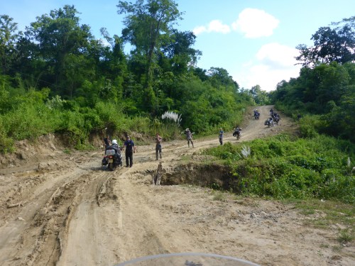 Anthony crossing the wooden log bridge under the creek bed on day 2 with those ahead waiting to help us