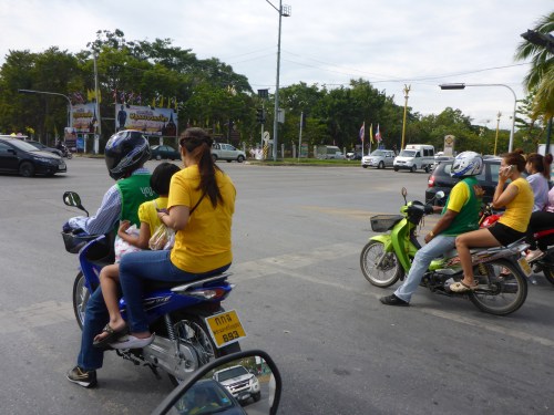Yellow t-shirts worn by moped-taxi passengers, Ayutthaya, Thailand
