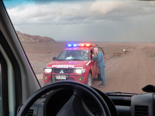 Now safely in our rescue vehicule, Martin stops to update the authorities who have heard of all the people stranded in the valley