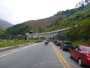 Following local riders past a long line of stopped traffic down the mountain