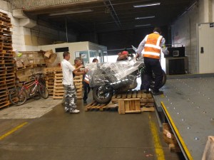 Getting the motorbikes up onto the departure bay