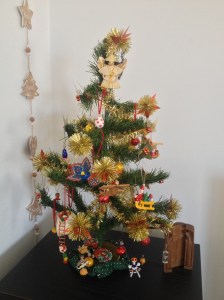 Our beloved 35 year old Christmas tree with miniature mementoes of our travels